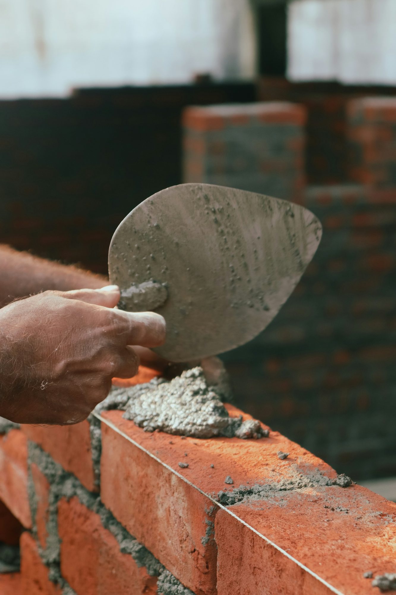 Bricklayer spreading mortar with a trowel